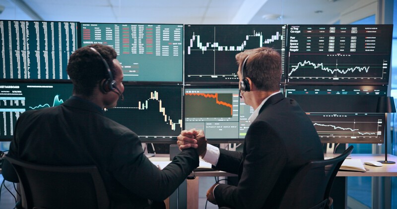 Business men, screen and computer with handshake of trading, partnership and increase of stock mark.